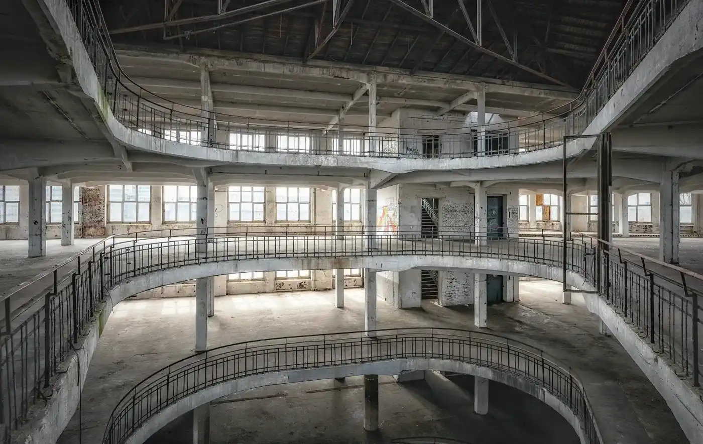 Verlassene, leerstehende Industriehalle mit mehreren Galerien als Sinnbild für einen aufgegebenen Unternehmensstandort